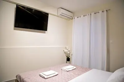 a bedroom with a bed with two towels on it at Attiki Sunshine Apartment With Terrace VIPGreece in Athens