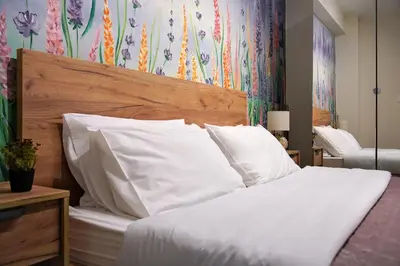 a bedroom with a bed with white pillows at Attiki Sunshine Apartment With Terrace VIPGreece in Athens