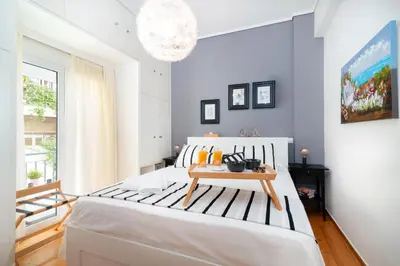 a bedroom with a large bed with a table on it at Athena by Heloni Apartments in Athens