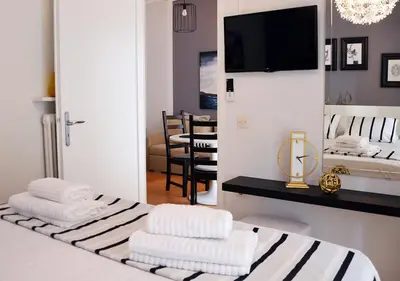 a room with a bed with three towels on it at Athena by Heloni Apartments in Athens