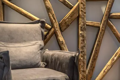 a room with two chairs and a wall with wooden beams at Noma Hotel in Athens