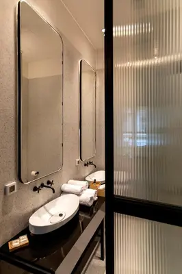 a bathroom with a sink and a mirror at Noma Hotel in Athens