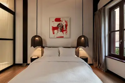 a bedroom with a large white bed and a window at Noma Hotel in Athens