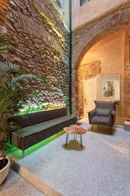 a room with a couch and a chair and a table at Noma Hotel in Athens