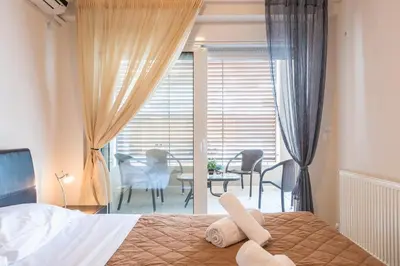 a bedroom with a bed and a table and chairs at Comfortable,sunny apartment in Athens Center in Athens