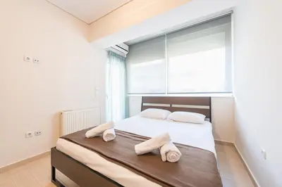 a bedroom with a bed with towels on it at Comfortable,sunny apartment in Athens Center in Athens