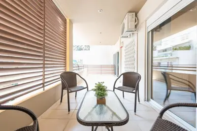 a small balcony with a table and chairs at Comfortable,sunny apartment in Athens Center in Athens