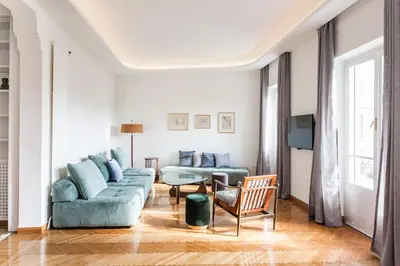 a living room with a couch and a chair at Athens Heritage Suite in Athens