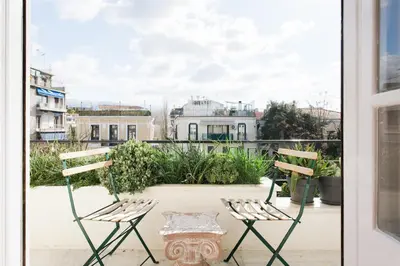 a pair of chairs sitting on a balcony at Athens Heritage Suite in Athens