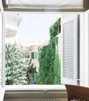 a window view of a garden from a house at Athens Heritage Suite in Athens