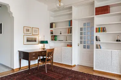 a home office with a desk and book shelves at Athens Heritage Suite in Athens