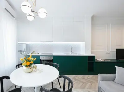 a kitchen with a white table and green cabinets at Athenian Sensations Apartments and Suites in the Heart of Athens in Athens