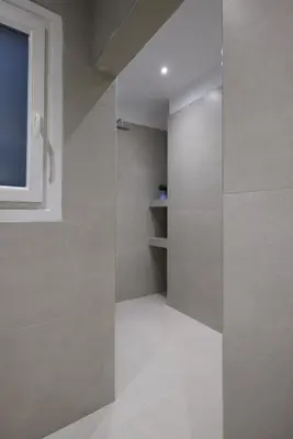 a walk in shower in a room with a window at Athenian Sensations Apartments and Suites in the Heart of Athens in Athens