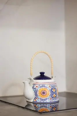 a blue and white tea pot sitting on a table at Athenian Sensations Apartments and Suites in the Heart of Athens in Athens