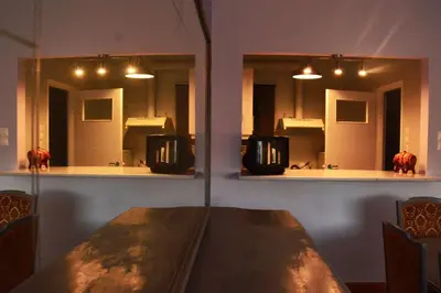 a bathroom with two mirrors and a table in front of it at Vintage, spacious apartment in the heart of Athens! in Athens