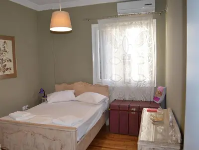a small bedroom with a bed and a window at Vintage, spacious apartment in the heart of Athens! in Athens
