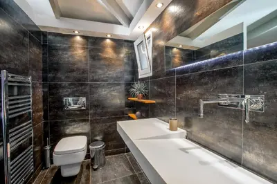 a bathroom with a sink and a toilet at Spa Villa34 Family resort Renew, Relax, Revitalise in Aghia Marina