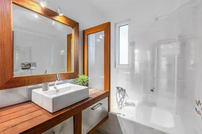 a bathroom with a white sink and a tub at Spa Villa34 Family resort Renew, Relax, Revitalise in Aghia Marina