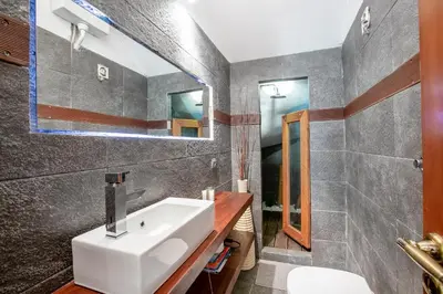 a bathroom with a sink and a mirror at Spa Villa34 Family resort Renew, Relax, Revitalise in Aghia Marina