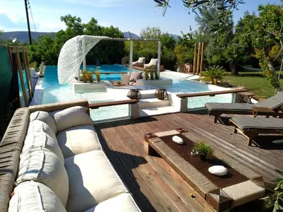 a backyard with a pool with a couch and a table at Spa Villa34 Family resort Renew, Relax, Revitalise in Aghia Marina