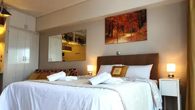 a bedroom with two beds with white sheets at Cozy Apartment in the Heart of Athens 8-1 in Athens