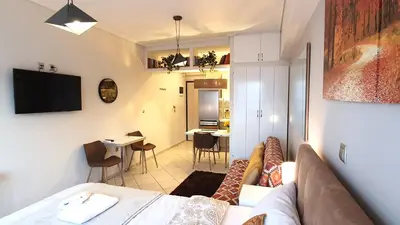 a living room with a couch and a dining room at Cozy Apartment in the Heart of Athens 8-1 in Athens