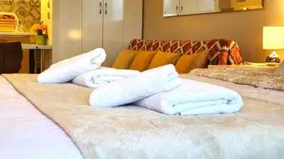 a pile of towels sitting on top of a bed at Cozy Apartment in the Heart of Athens 8-1 in Athens
