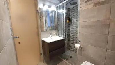 a bathroom with a sink and a glass shower at Cozy Apartment in the Heart of Athens 8-1 in Athens