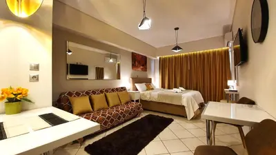a living room with a couch and a bed in a room at Cozy Apartment in the Heart of Athens 8-1 in Athens