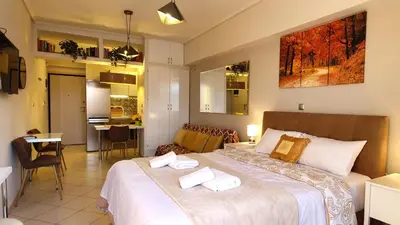 a bedroom with a large bed with two towels on it at Cozy Apartment in the Heart of Athens 8-1 in Athens