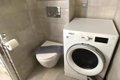 a bathroom with a washing machine and a toilet at Cozy Apartment in the Heart of Athens 8-1 in Athens