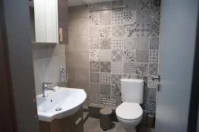 a bathroom with a toilet and a sink at 2the Point Athens Suites & Appartments in Plaka in Athens