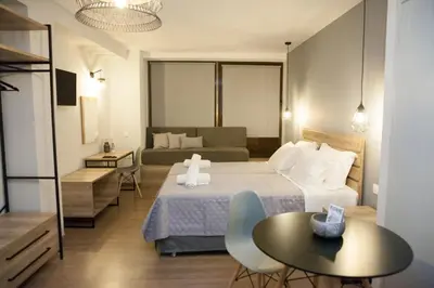 a hotel room with a bed and a table at 2the Point Athens Suites & Appartments in Plaka in Athens