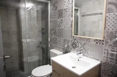 a bathroom with a toilet and a sink and a shower at 2the Point Athens Suites & Appartments in Plaka in Athens