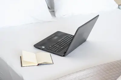 a laptop computer sitting on a desk with a book at Dreamy Athens Penthouse With Acropolis View in Athens