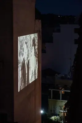 a picture of a bride and groom on the side of a building at night at Dreamy Athens Penthouse With Acropolis View in Athens