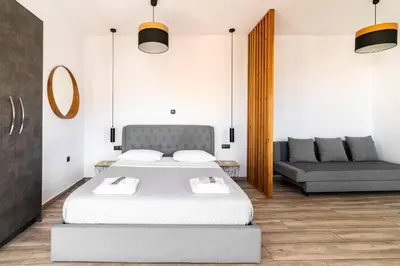a bedroom with a bed and a couch at Dreamy Athens Penthouse With Acropolis View in Athens