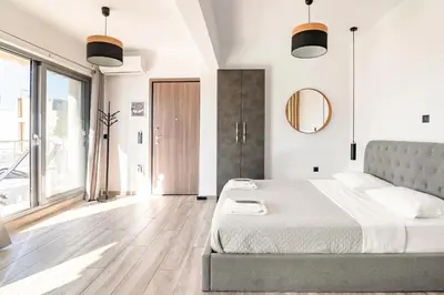 a bedroom with a bed and a large window at Dreamy Athens Penthouse With Acropolis View in Athens