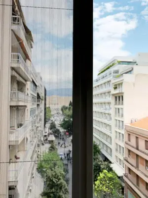 a view of a city street from a window at CosmosDome. Best view in the heart of Athens! in Athens