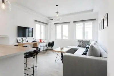 a living room with a couch and a table at CosmosDome. Best view in the heart of Athens! in Athens