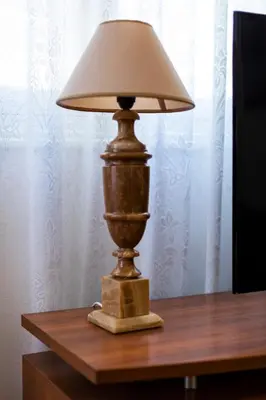 a lamp sitting on top of a wooden table at Delightful 2 BEDR-2 BATH Apt with Access to Rooftop Garden - EP9U in Athens