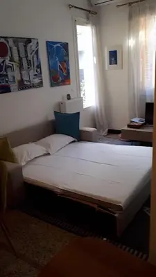 a large bed in a room with a window at Delightful 2 BEDR-2 BATH Apt with Access to Rooftop Garden - EP9U in Athens