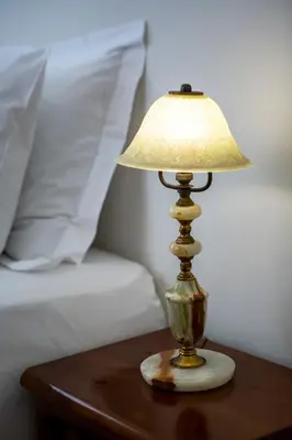 a lamp sitting on a table next to a bed at Delightful 2 BEDR-2 BATH Apt with Access to Rooftop Garden - EP9U in Athens