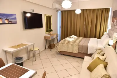 a hotel room with a bed and a couch at Cozy Apartment in the Heart of Athens 8-2 in Athens