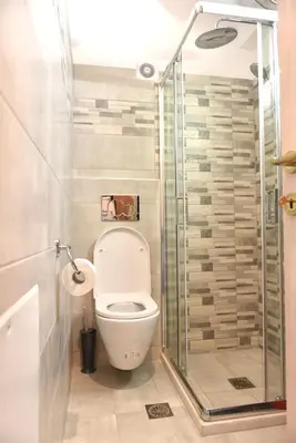 a bathroom with a toilet and a glass shower at Cozy Apartment in the Heart of Athens 8-2 in Athens