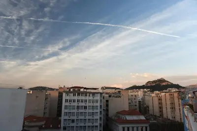a view of a city with buildings and planes in the sky at Cozy Apartment in the Heart of Athens 8-2 in Athens