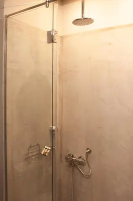 a shower with a glass door in a bathroom at Athens Blossom House under Acropolis with private entrance in Athens