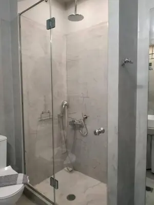 a shower with a glass door in a bathroom at Athens Blossom House under Acropolis with private entrance in Athens