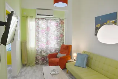 a living room with a couch and a chair at Athens historical center Love suite 2 in Athens