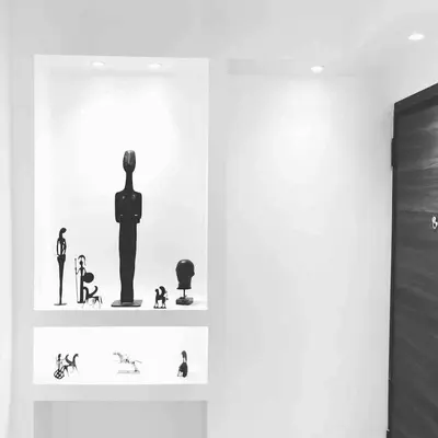 a shelf with figurines of a man on it at Athens historical center Love suite 2 in Athens